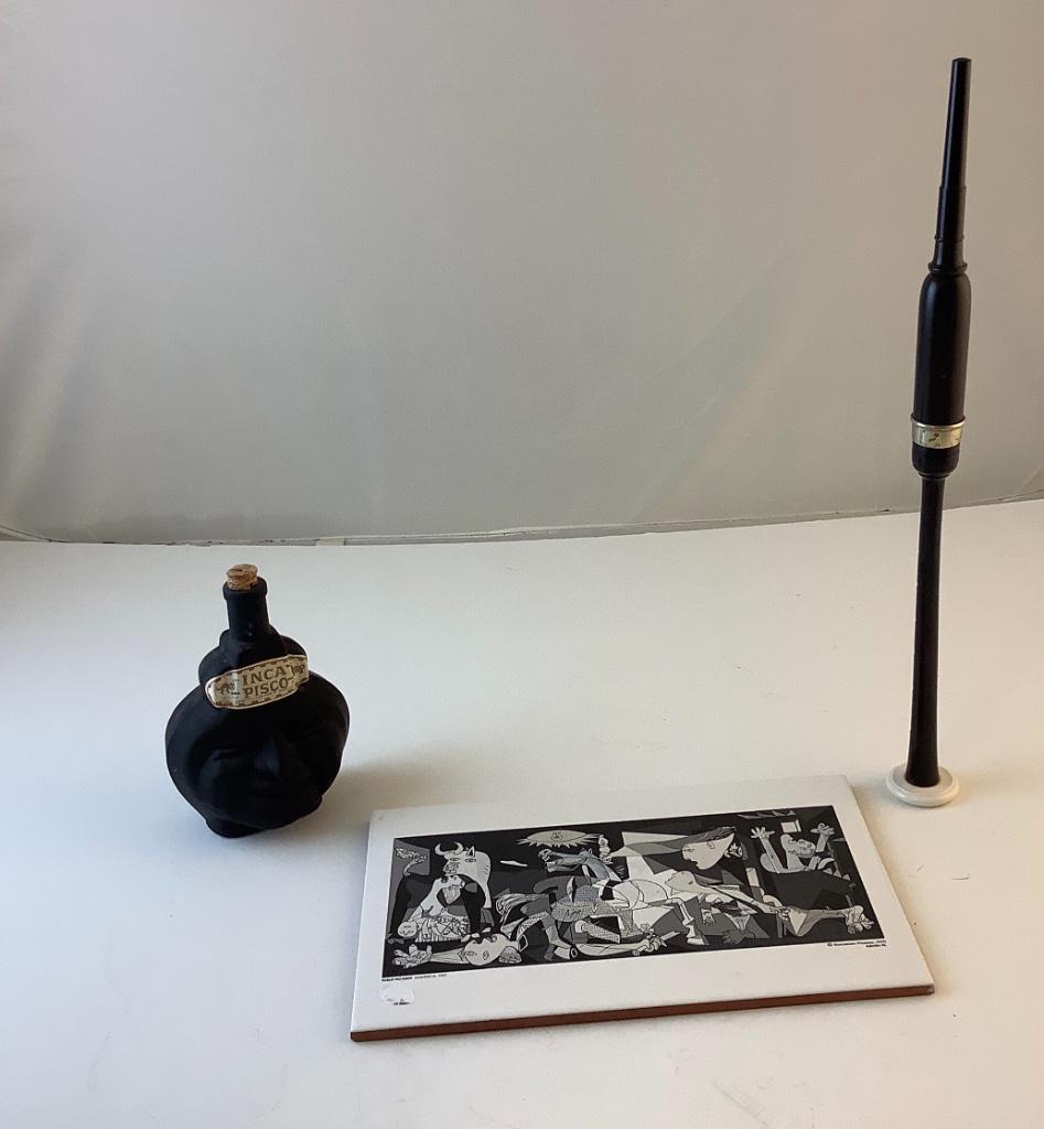 Tribal Flute 18” long ,7” empty bottle of Inca Pisco.w/: Tribal Flute 18” long ,7” empty bottle of Inca Pisco.w/ face on bottle. Wall hanging plate.