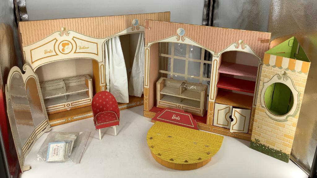 Barbie Fashion Shop-tape-box torn-plastic showcase has: Barbie Fashion Shop-tape-box torn-plastic showcase has a bend in it-box torn-plastic bent on left side-chair missing-is very dirty.