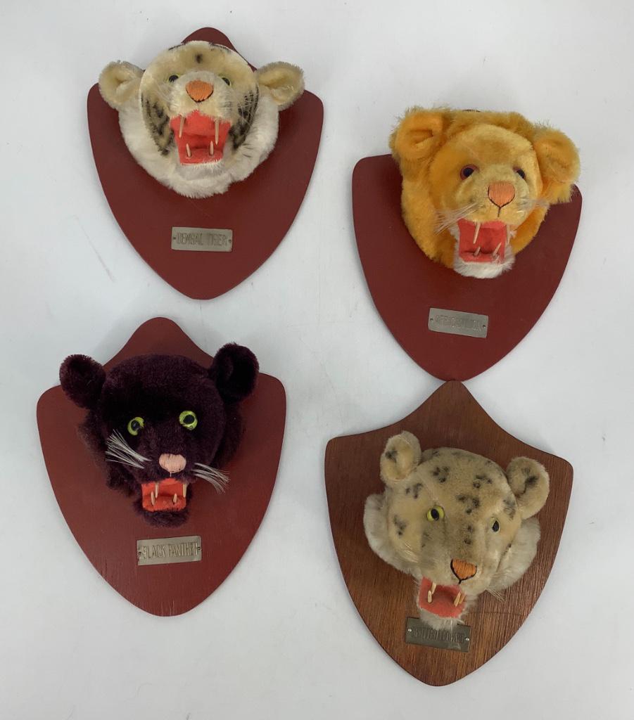 (4) plush animal mounts. Similar to ones produced by: (4) plush animal mounts. Similar to ones produced by Steiff, each head is made of synthetic plush with applied ears, plastic eyes, stitched noses, plastic teeth, mounted on display backs with name pla