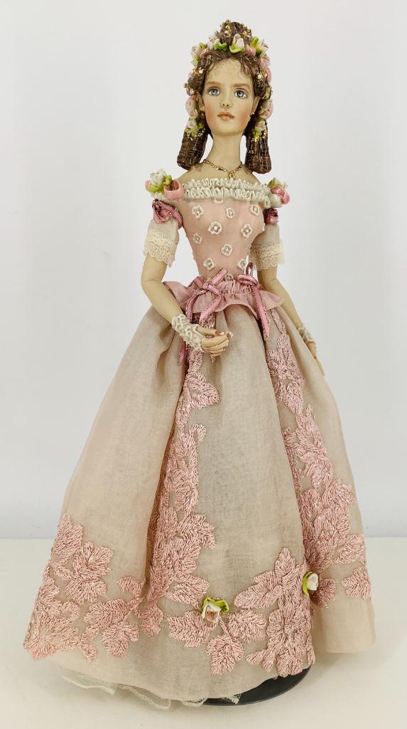 Artist created lady in pink by Kathy Redmond. 14 1/2": Artist created lady in pink by Kathy Redmond. 14 1/2" doll, molded and painted one-piece head/torso/hips, cloth upper legs and arms. Incredibly detailed with applied roses in her hair and on her skirt