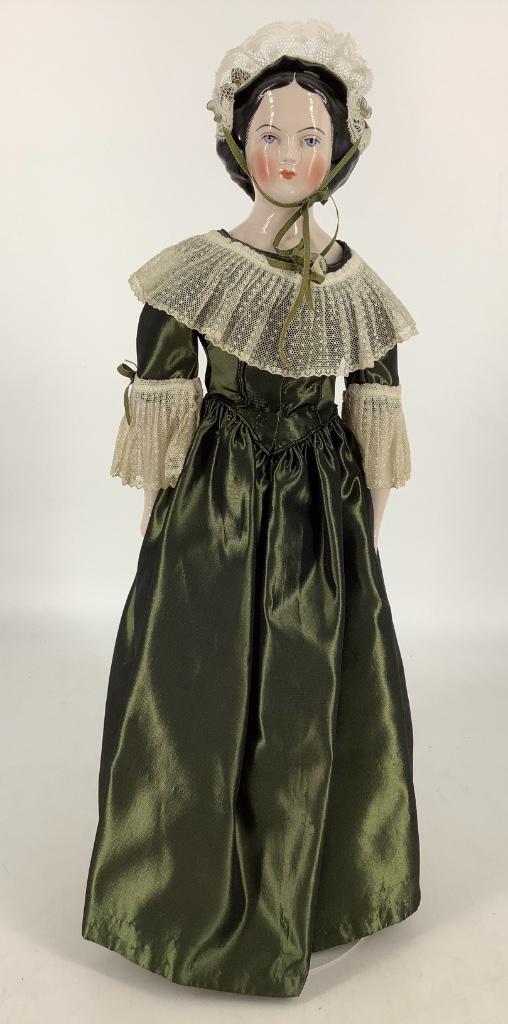 Reproduction Jenny Lind china shoulder head doll by: Reproduction Jenny Lind china shoulder head doll by Emma Clear. Marked "Clear 49", molded and painted hair and facial features, on firmly stuffed stitch-jointed cloth body with china lower arms and le