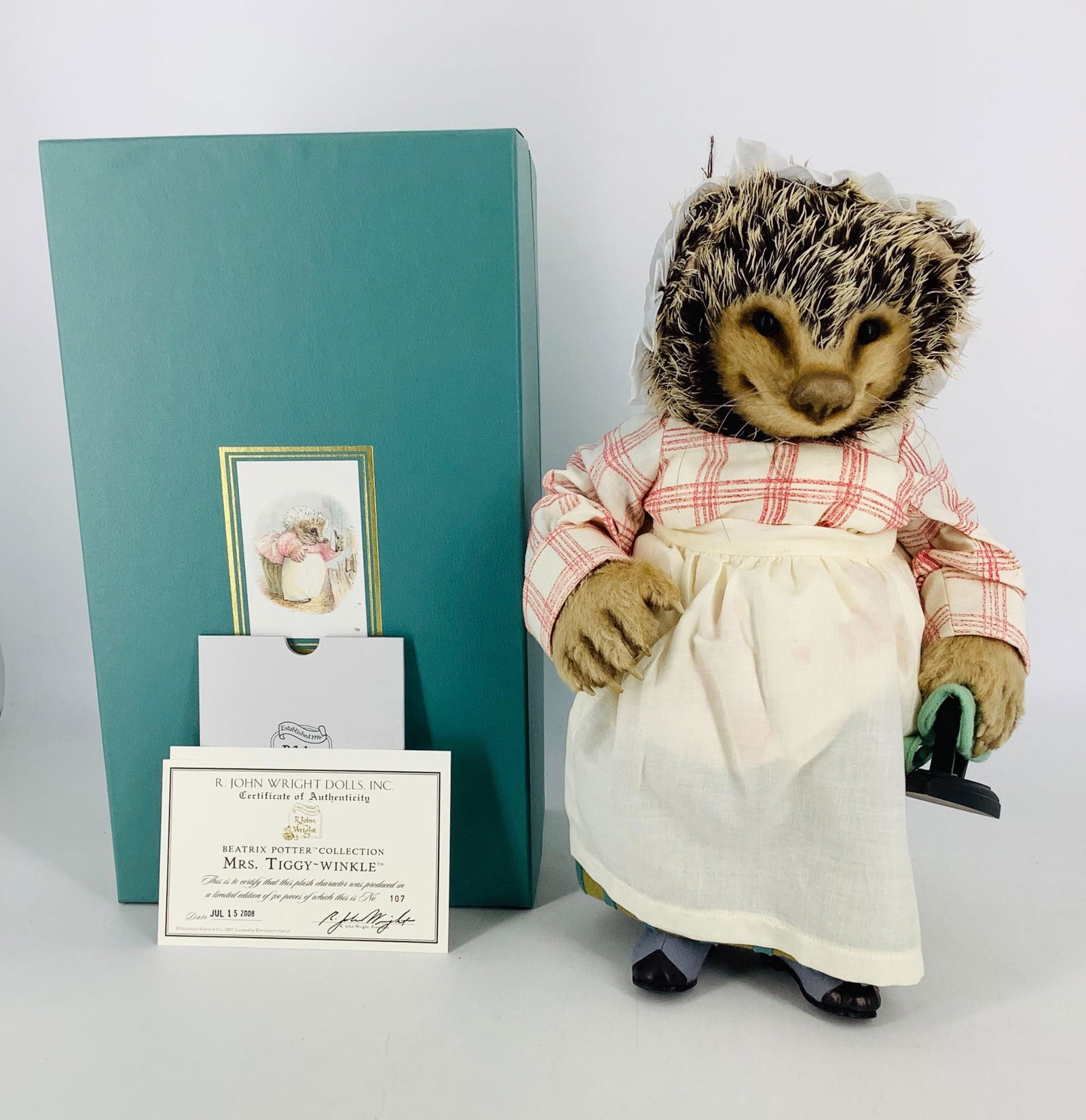 Mrs. Tiggy-Winkle by R. John Wright. From the Beatrix: Mrs. Tiggy-Winkle by R. John Wright. From the Beatrix Potter Collection, fully jointed mohair 12" hedgehog with molded features, glass eyes and resin claws, dressed in hand printed cotton clothing wit