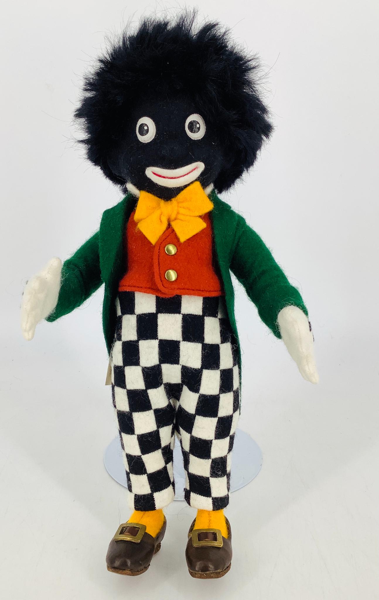 "Golliwogg" by R. John Wright. The 1st exclusive: "Golliwogg" by R. John Wright. The 1st exclusive offering of the R. John Wright Collector Club, the 11" all felt Golliwogg has molded and painted facial features and a five-piece body. He is dressed i