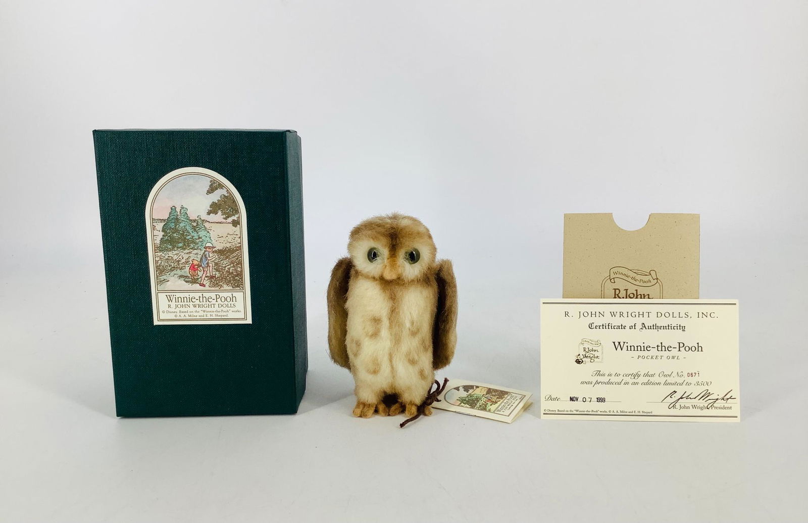 Winnie-the-Pooh "Pocket Owl" by R. John Wright. 4 1/2": Winnie-the-Pooh "Pocket Owl" by R. John Wright. 4 1/2" mohair plush Owl jointed at neck, with moveable wings and glass eyes. He is Limited Edition No. 671/3500 and comes in his original box with COA.