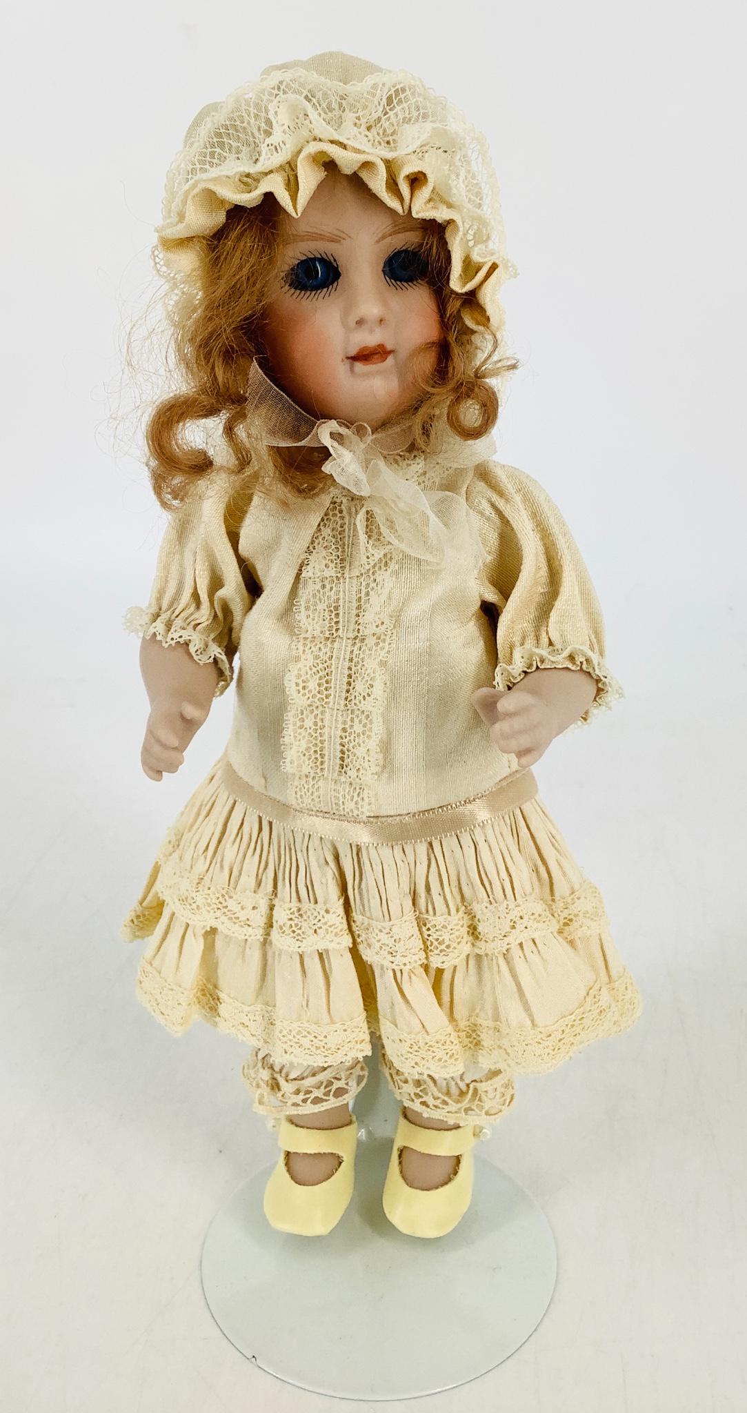 Reproduction all-bisque girl. 9" socket head doll with (1 of 2)