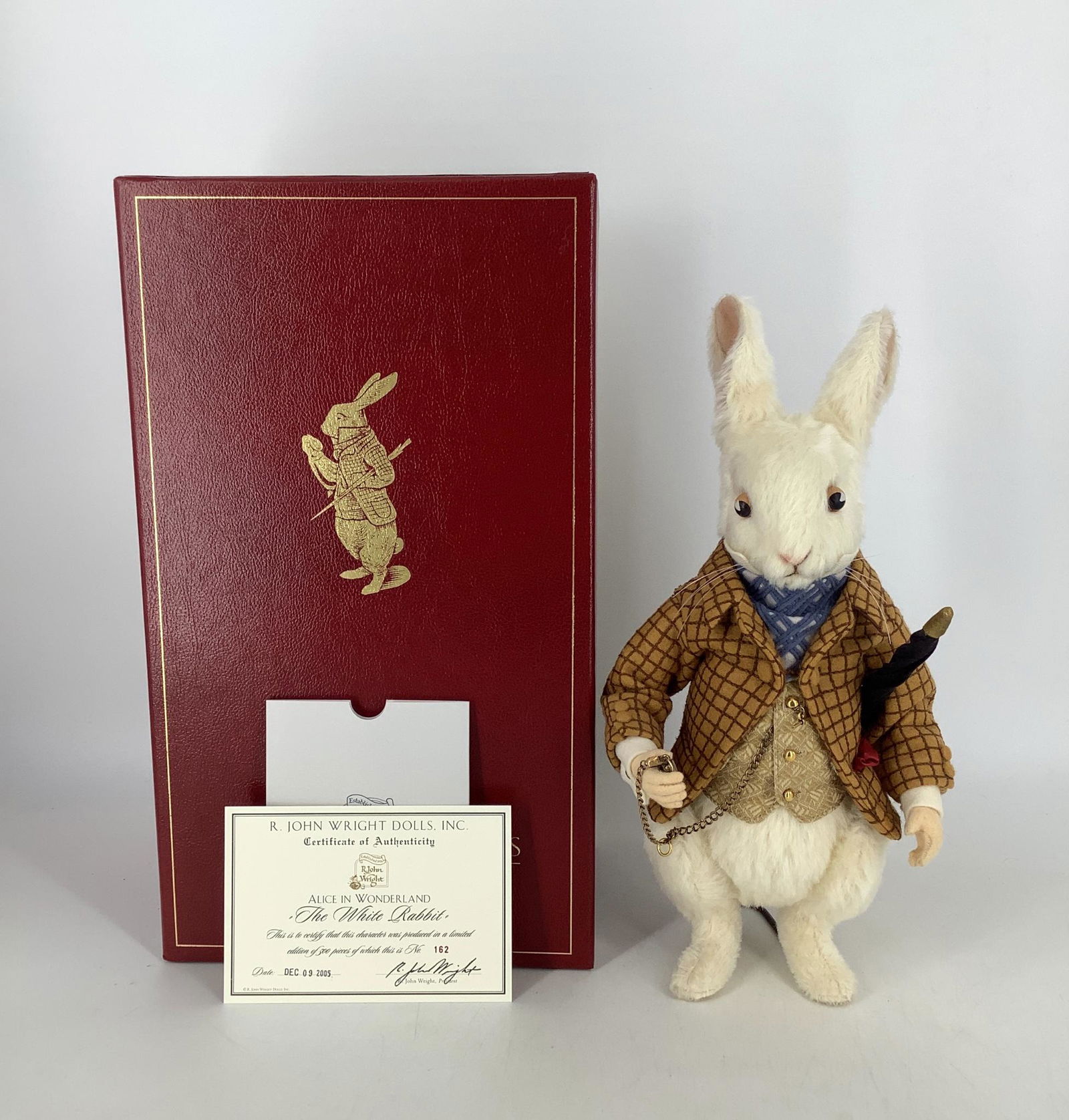 "The White Rabbit" by R. John Wright. From the Alice in: "The White Rabbit" by R. John Wright. From the Alice in Wonderland collection, the 13" White Rabbit is made of alpaca plush with felt hands, fully jointed, painted leather eyes, embroidered features.