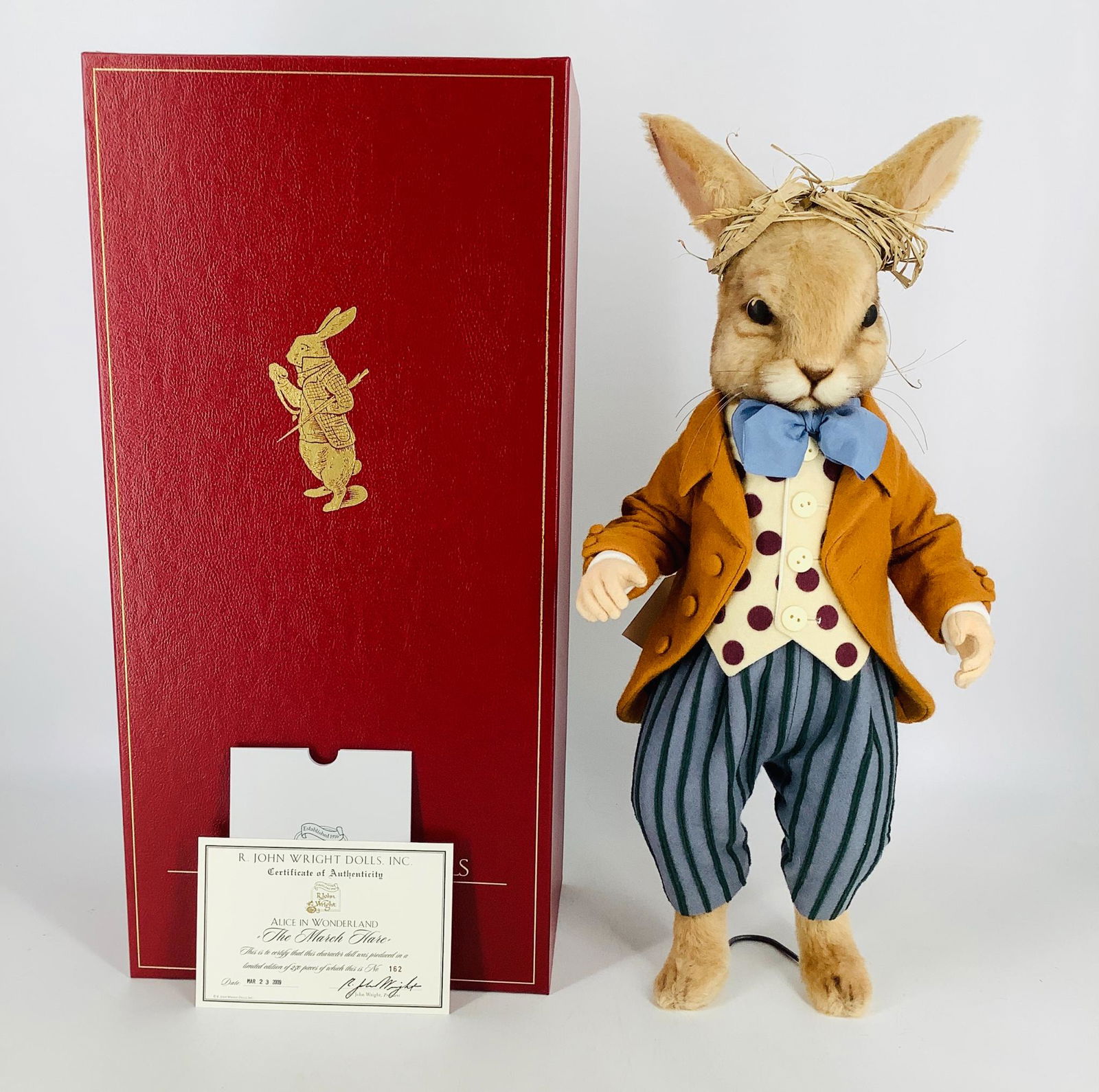 "The March Hare" by R. John Wright. From the Alice in: "The March Hare" by R. John Wright. From the Alice in Wonderland collection, the 17" mohair plush March Hare is fully jointed with molded felt hands. He wears a pieced wool felt period costume with a