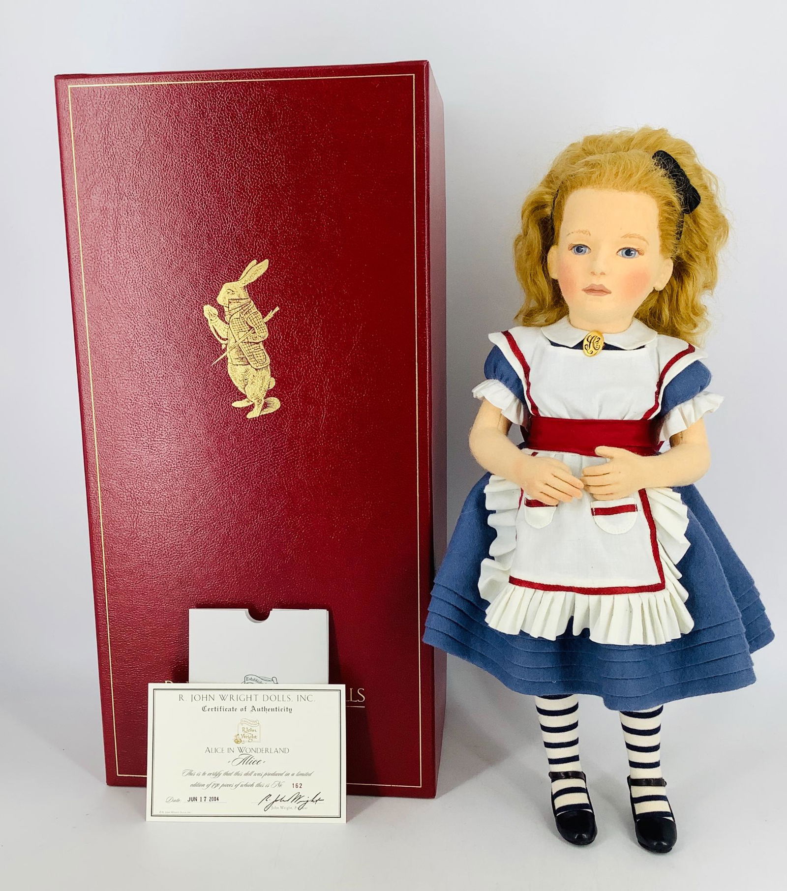 "Alice" by R. John Wright. From the Alice in Wonderland: "Alice" by R. John Wright. From the Alice in Wonderland collection, 17" Alice is all felt with molded and painted facial features, hand knotted mohair wig, jointed at the neck, shoulders and hips. Ali
