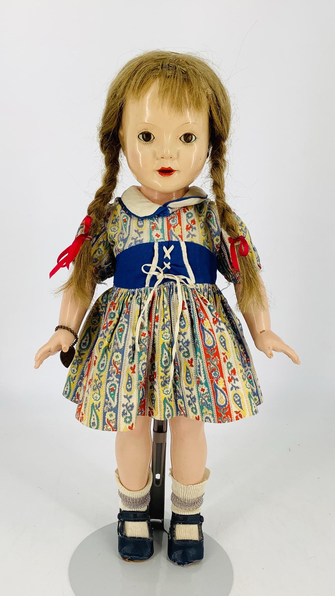 Effanbee composition "American Child". Designed by: Effanbee composition "American Child". Designed by Dewees Cochran, 17" girl with human hair wig, sleep eyes with eyelashes, open mouth, on five-piece body. Dressed in likely original clothing with Eff