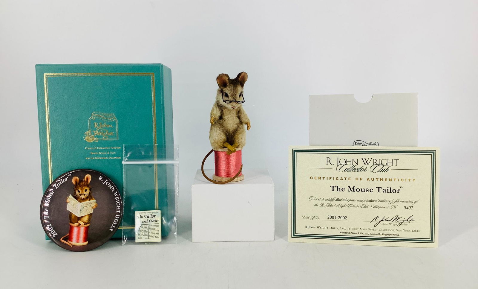 "The Mouse Tailor" by R. John Wright. Made exclusively: "The Mouse Tailor" by R. John Wright. Made exclusively for the R. John Wright Collector Club (2001/2002), the 3" mohair mouse sits atop a spool of thread reading a copy of "The Tailor and Cutter" news