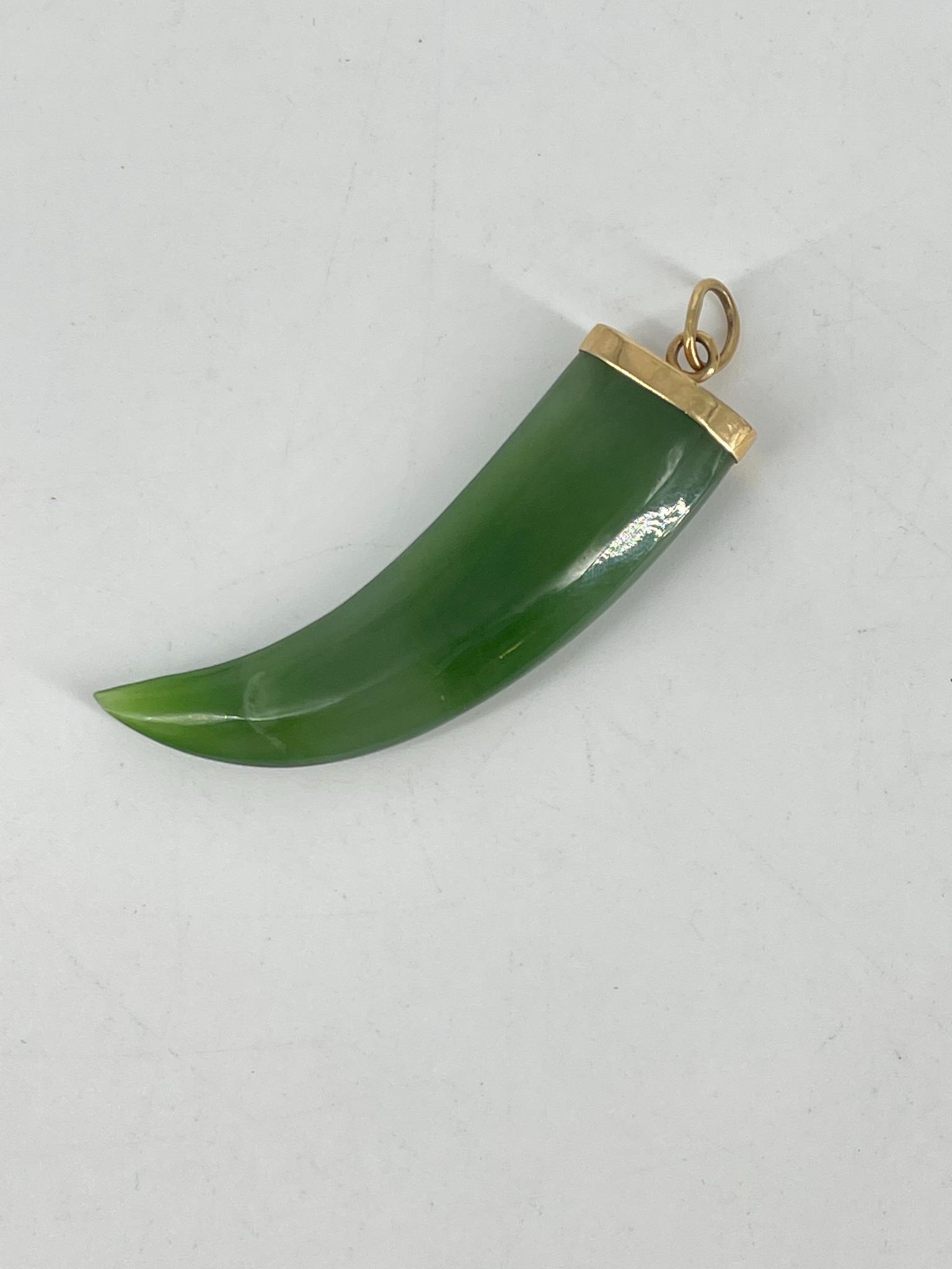 Jade Horn/Talon Pendant: Jade Horn/Talon Pendant 2" x 0.5" in size, with 14kt yellow gold bail attached (stamped and tested 585), unsigned. Polished green jade talon/horn with striations and mostly opaque body. Vintage age.