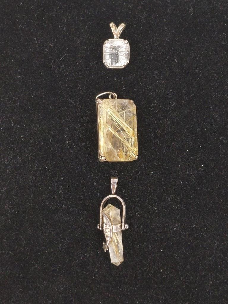 Sterling and Quartz Pendants: Sterling and Quartz Pendants Rutilated and Tourmalinated (schorl) quartz pendants, three in total, with sterling silver (tested) settings/bails. 0.75" - 1.5" in length (including bails). Unsigned pend