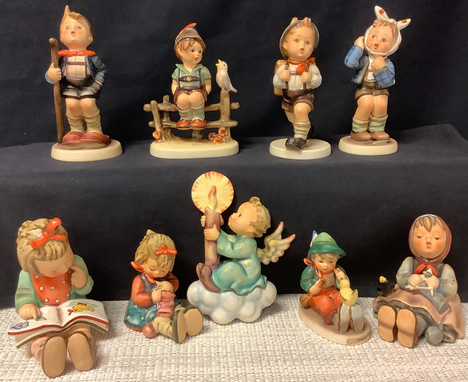 Lot of 9 Hummels including book worm & wayside harmony. (1 of 4)