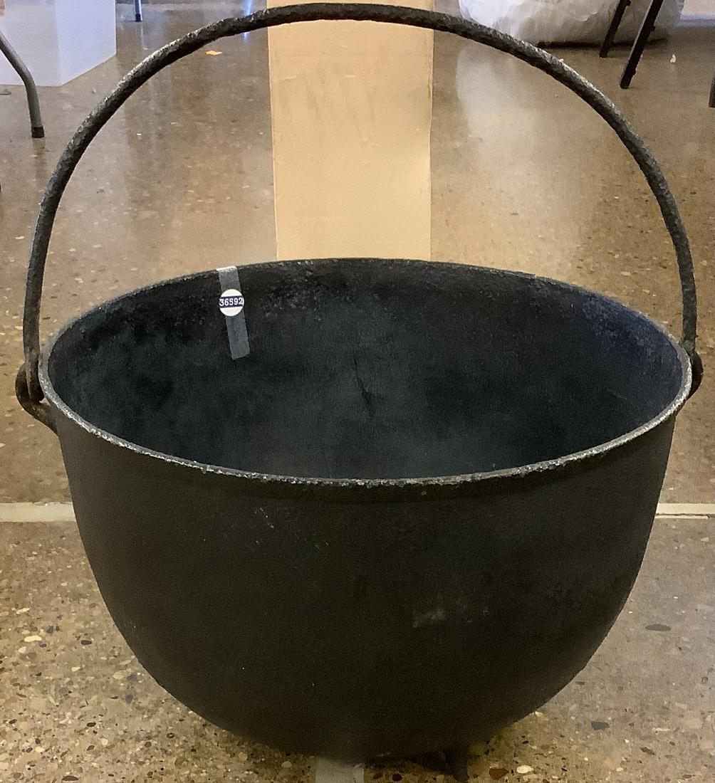 Large cast-iron kettle with handle 20 1/4” wide (1 of 1)