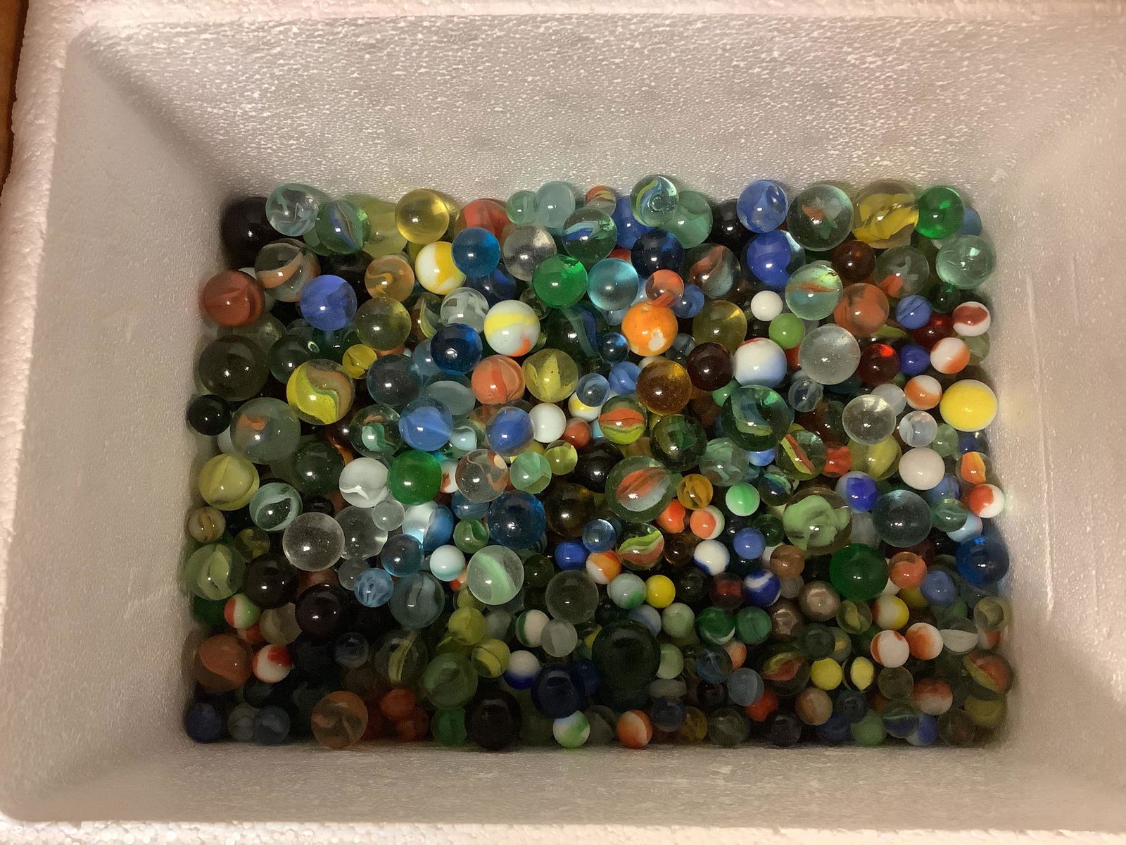 Wooden crate filled w/ marbles: Wooden crate filled w/ marbles