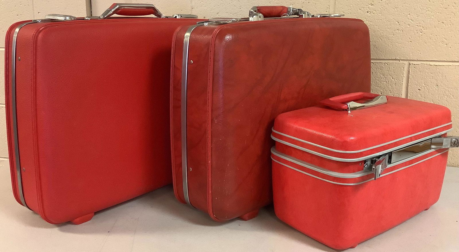 Lot of three pieces of red luggage. First is a mirrored (1 of 3)