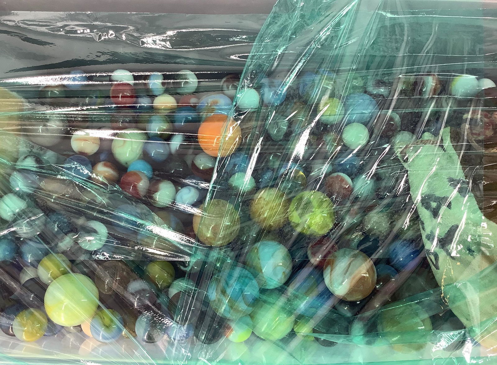 Container half full of marbles.: Container half full of marbles.