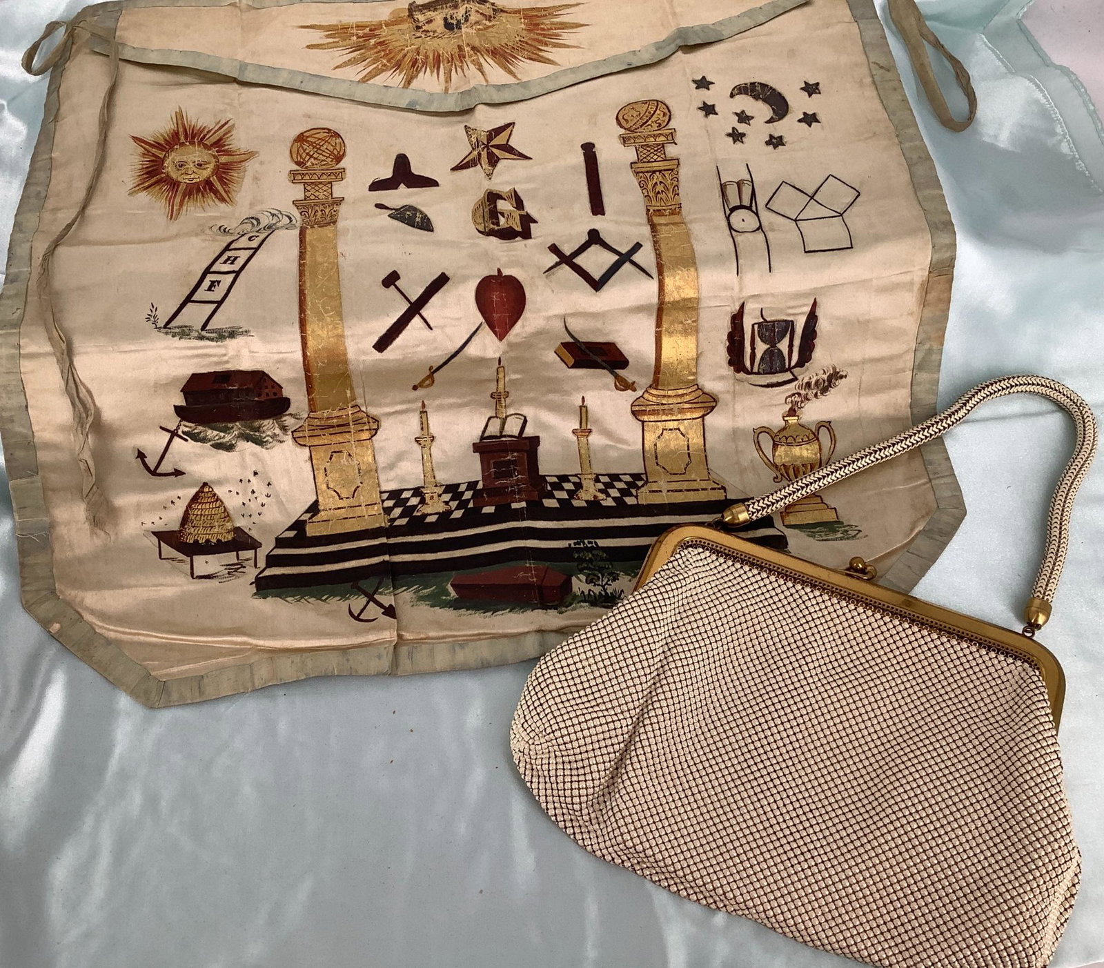 Lot includes an old hand-made painted silk Masonic: Lot includes an old hand-made painted silk Masonic apron-type item @ 15” tall and 17” wide and a cream-color Whiting & Davis purse @ 9” wide with a polished gold frame and mesh handl