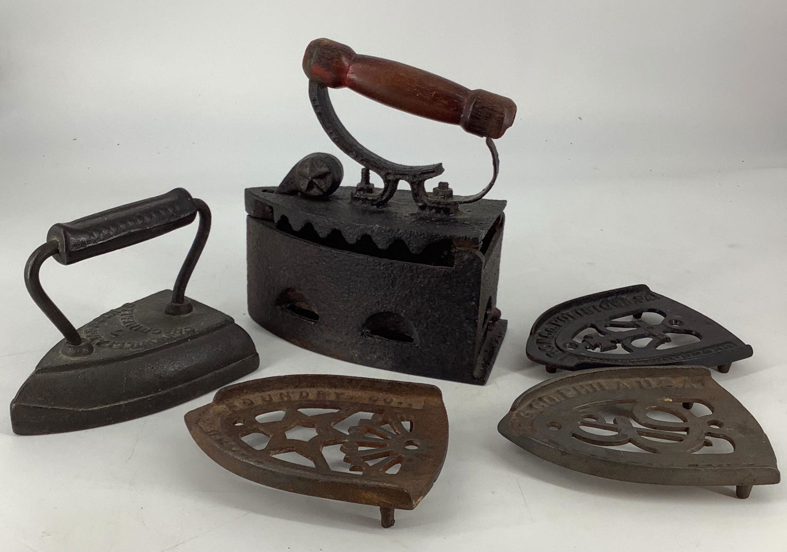 Lot of old irons and stands made of cast iron.: Lot of old irons and stands made of cast iron.