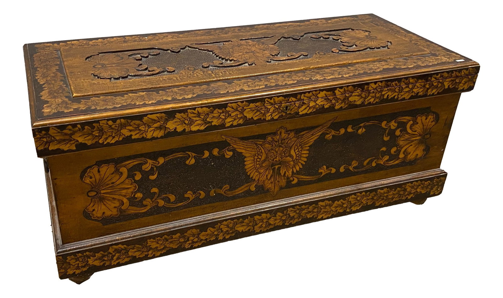 Great burntwood blanket chest, turn of the century with: Great burntwood blanket chest, turn of the century with Griffin and acorn motif, 49.5” x 21.5” x 21.5”