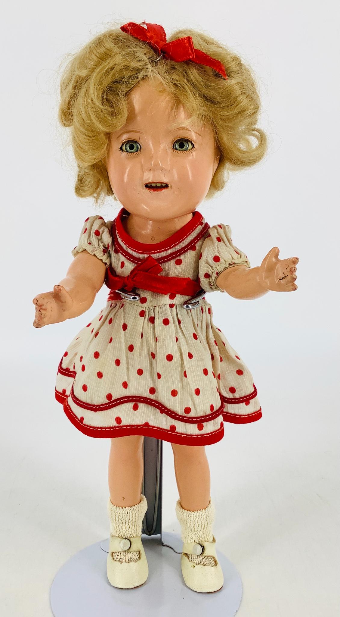 11" Ideal composition Shirley Temple. Mohair wig, tin: 11" Ideal composition Shirley Temple. Mohair wig, tin sleep eyes, open mouth with teeth, on five-piece composition body. Body and head marked "Shirley Temple 11". Shirley wears her original dress and 