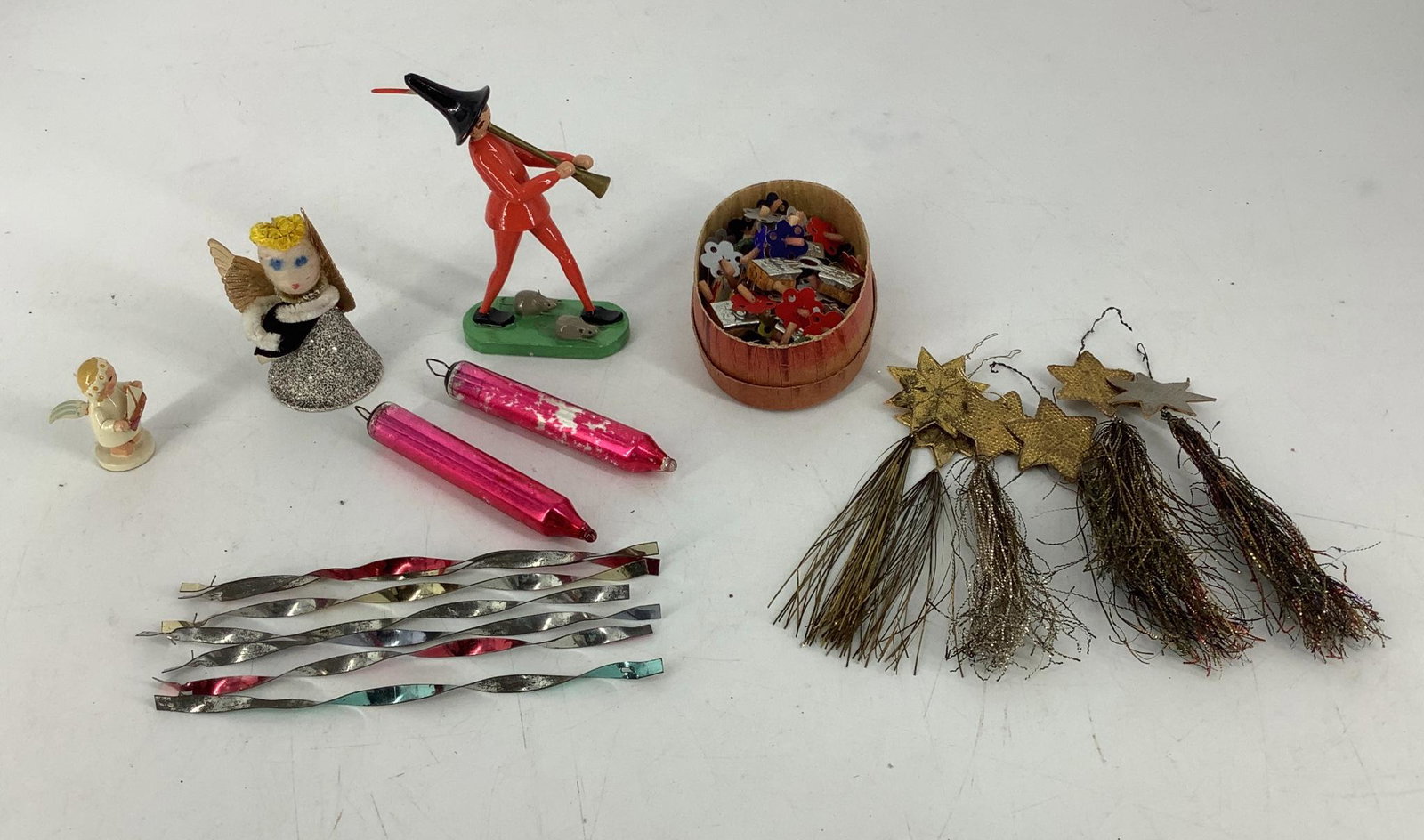 Vintage ornaments and figurines, including Pride Piper: Vintage ornaments and figurines, including Pride Piper marked Made in Germany East, paper angel marked Japan, angel marked Made in GDR, 6 foil and tinsel stars, 7 metal spirals measuring 5.5" each