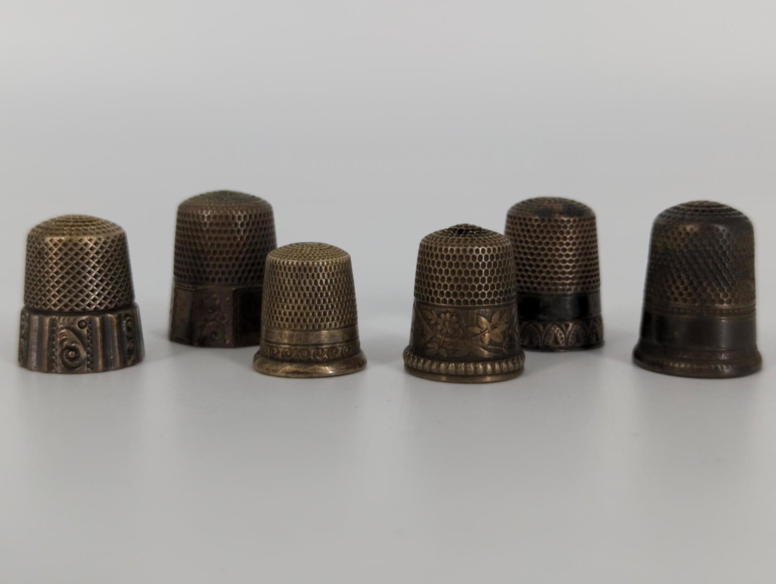Six Sterling Silver Thimbles: Six Sterling Silver Thimbles Three thimbles feature etched accents at the base, all pieces electronically tested (0.8 troy oz tw)