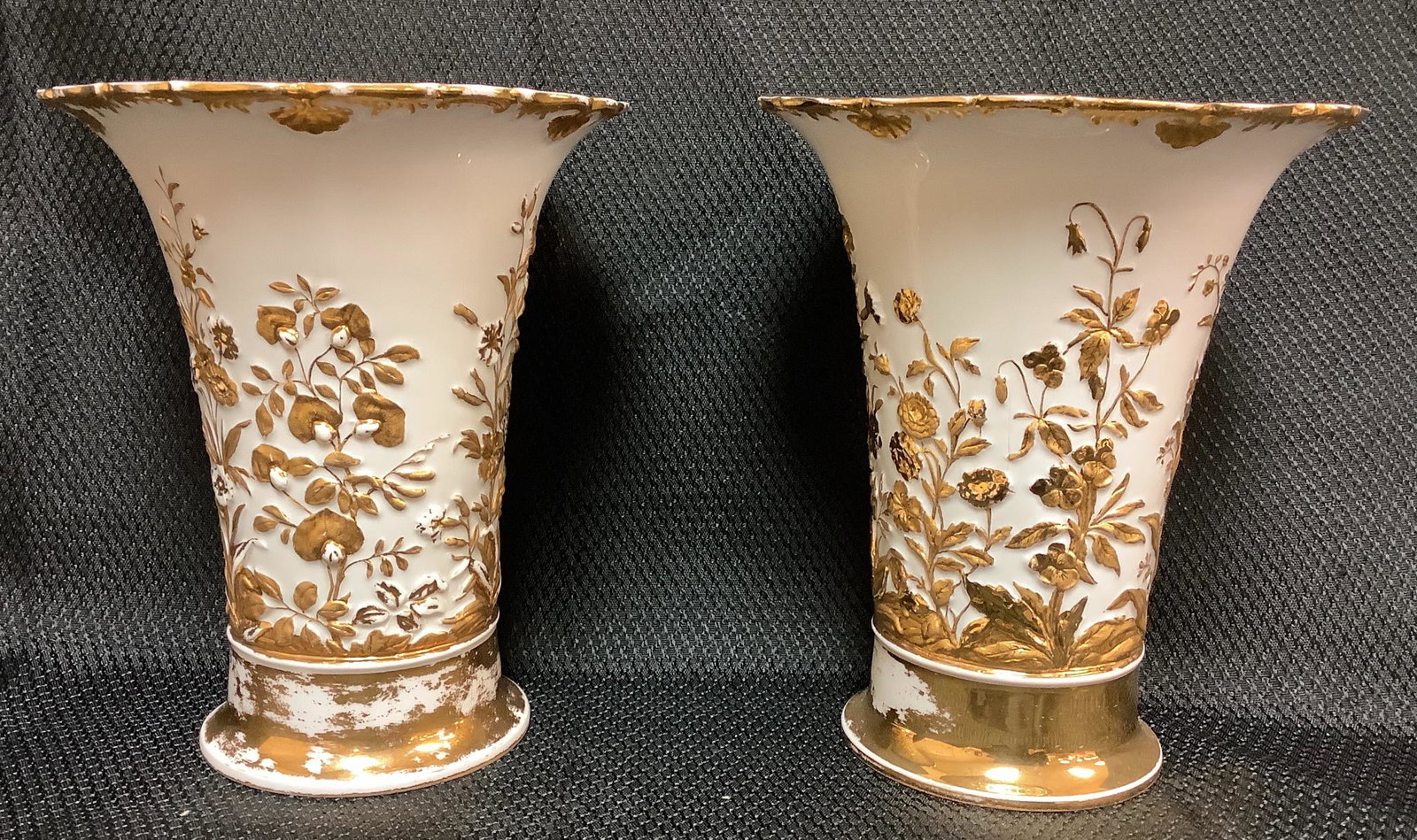 Pair of Meissen 6.5" tall vases. White with gold: Pair of Meissen 6.5" tall vases. White with gold foliage and floral design. Gold is wearing throughout. This lot is from DeBow Freed Trust.