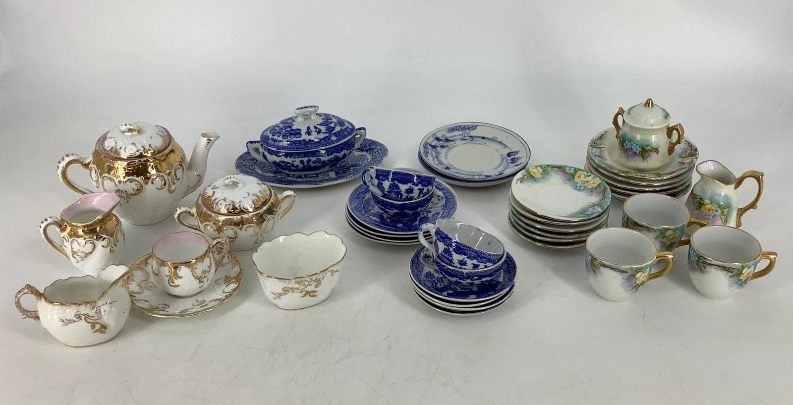 Miniature tea sets, ranging from 1"-3.5", marked as (1 of 7)