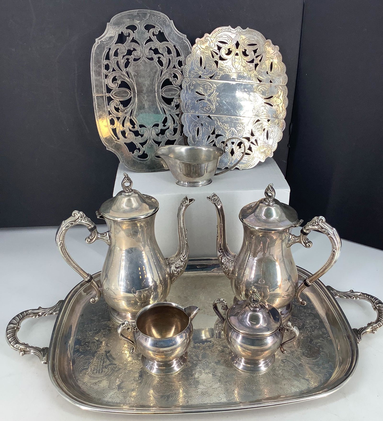 5 piece silver plated tea set including 23" long: 5 piece silver plated tea set including 23" long handled rectangular tray plus 2 expandable trivets and one gravy boat.