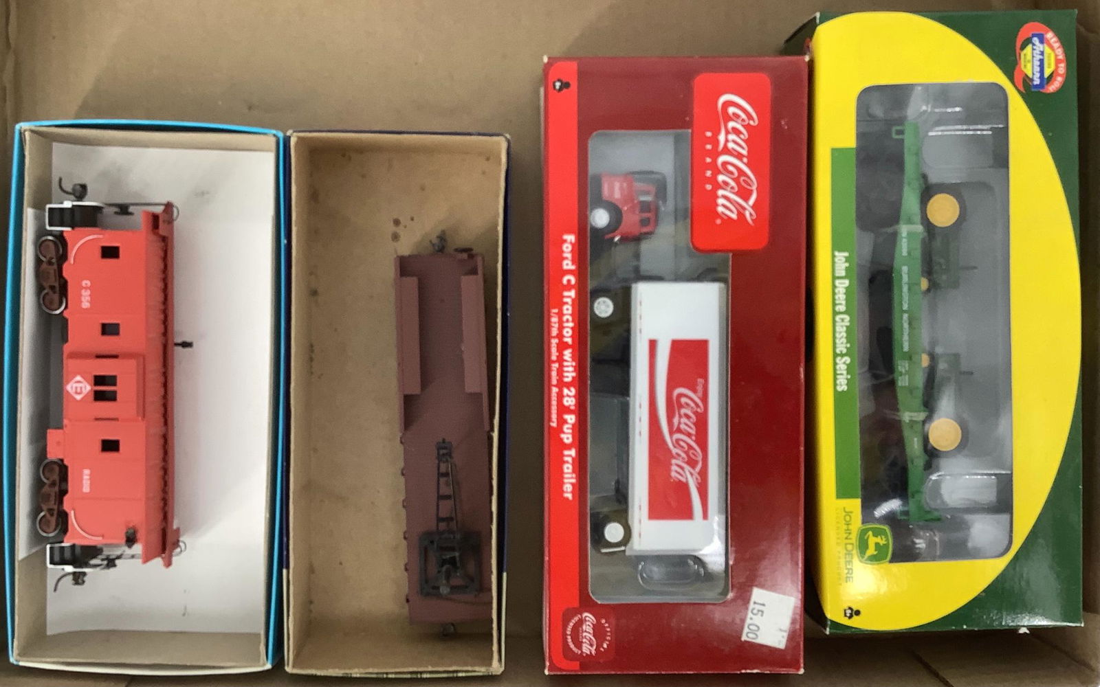 Three HO freight cars and a caboose in boxes. (1 of 1)