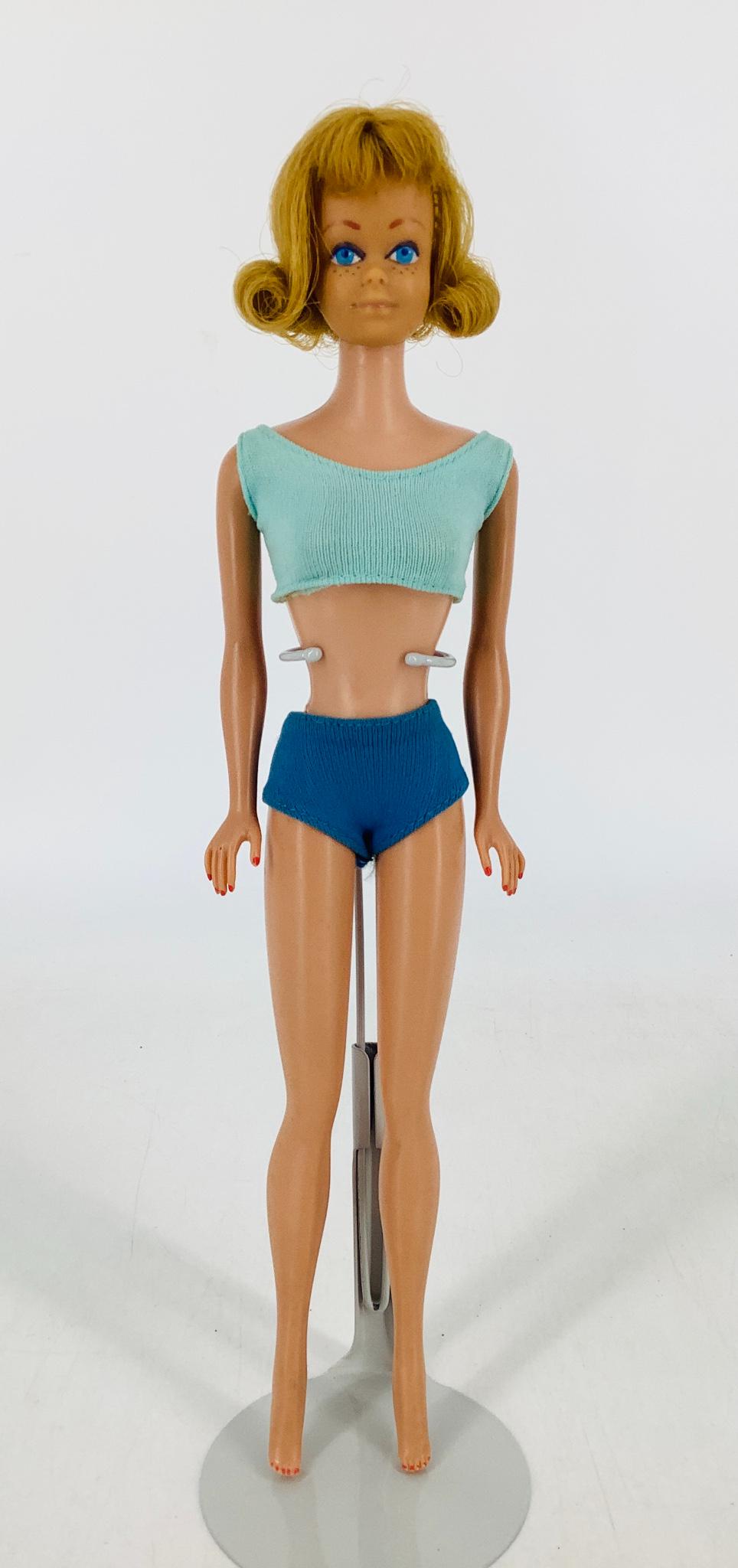 Beautiful Blond haired Midge with original bathing: Beautiful Blond haired Midge with original bathing suit, booklet and stand. Toes & finger nails painted but lips are very light.