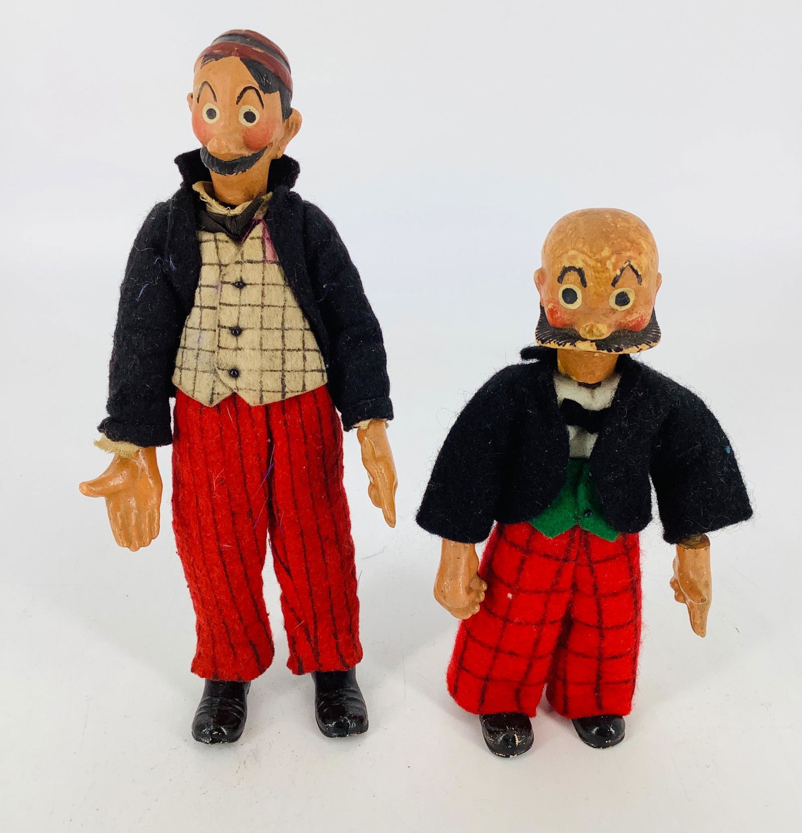 Bucherer Mutt and Jeff. Swiss made jointed metal dolls,: Bucherer Mutt and Jeff. Swiss made jointed metal dolls, 6 1/2" and 8" with painted heads, hands and shoes, dressed in wool felt clothing. Both have typical wear.