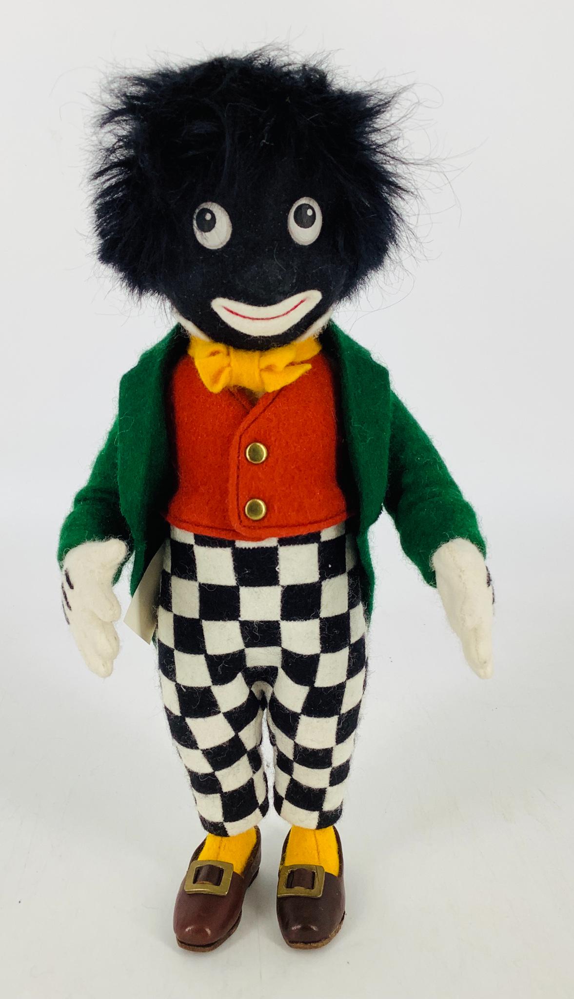 "Golliwogg' by R. John Wright. All felt 10" doll is: "Golliwogg' by R. John Wright. All felt 10" doll is jointed at the neck, shoulders and hips, with mohair wig, molded and painted head, applied felt mouth, dressed in wool felt attire with leather shoe