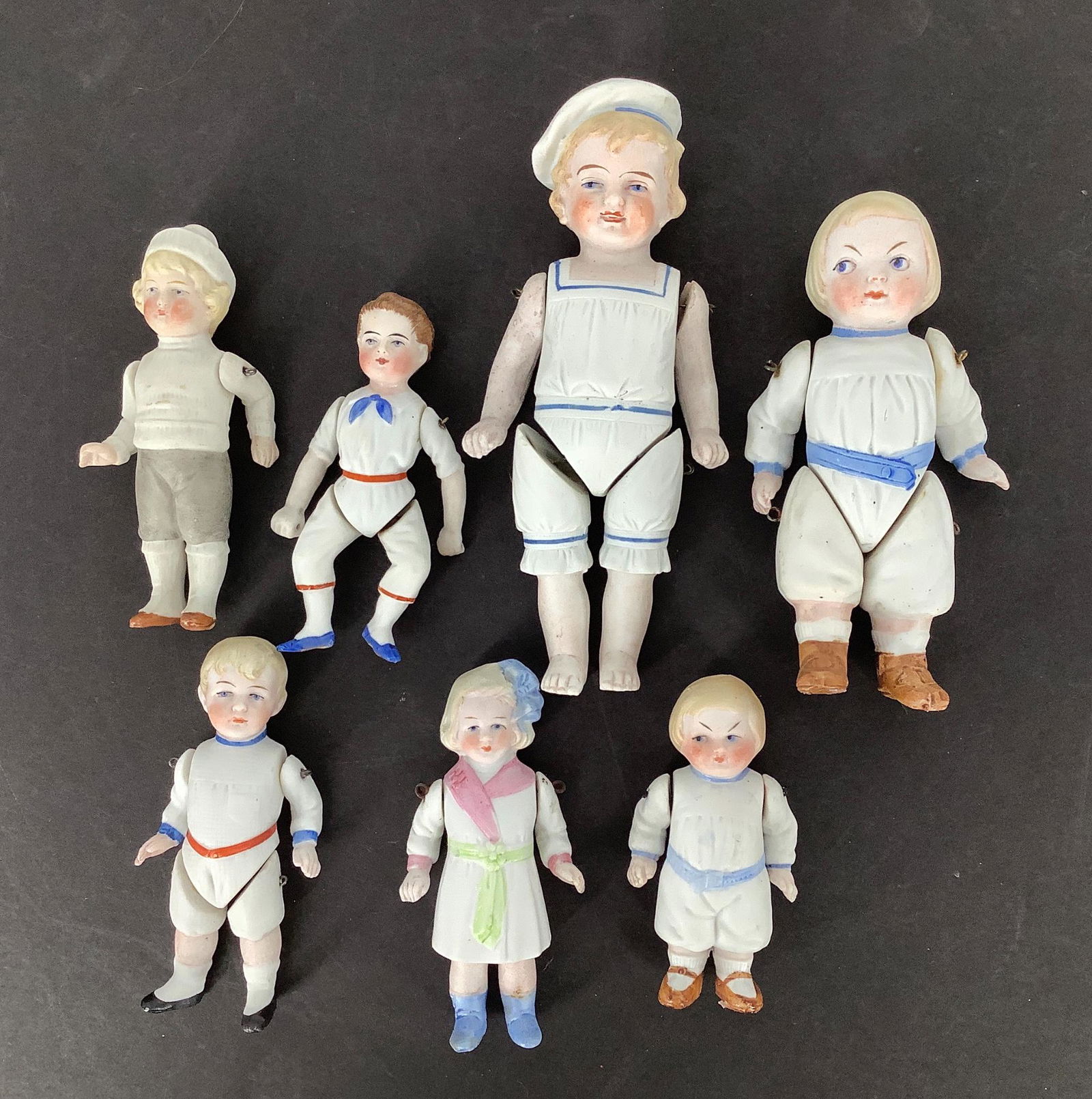 Lot (7) small all-bisque novelty dolls with molded and (1 of 4)