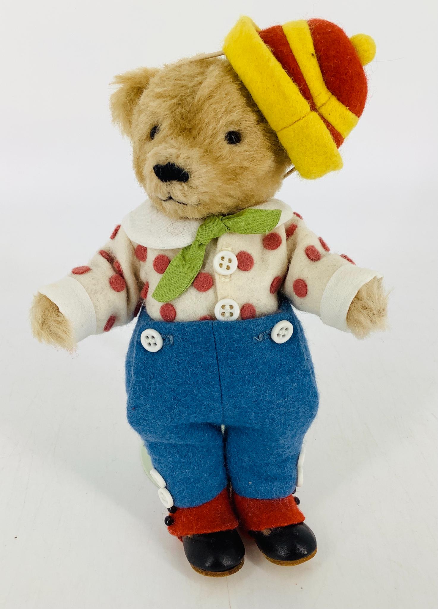"The Little Brown Bear" by R. John Wright. From the: "The Little Brown Bear" by R. John Wright. From the Forever Friends series, 7 1/2" mohair bear is jointed at the neck, shoulders and hips, dressed in wool felt with leather shoes and spats. Made exclu