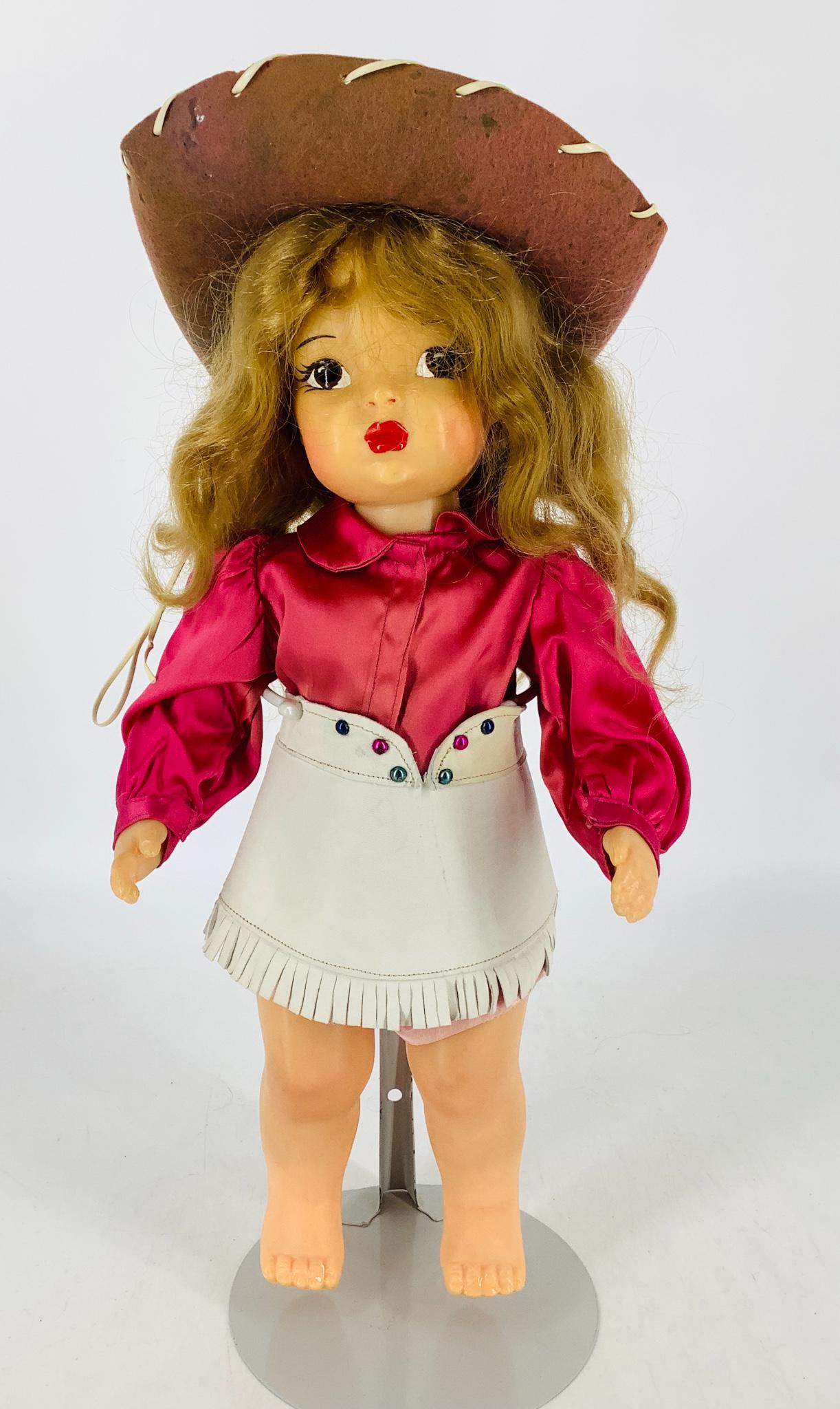 Terri Lee Cowgirl. 16" doll with synthetic wig, molded: Terri Lee Cowgirl. 16" doll with synthetic wig, molded and painted facial features, on five-piece body marked "Terri Lee Pat. Pending". Terri wears a plum colored satin blouse and white leather skirt.