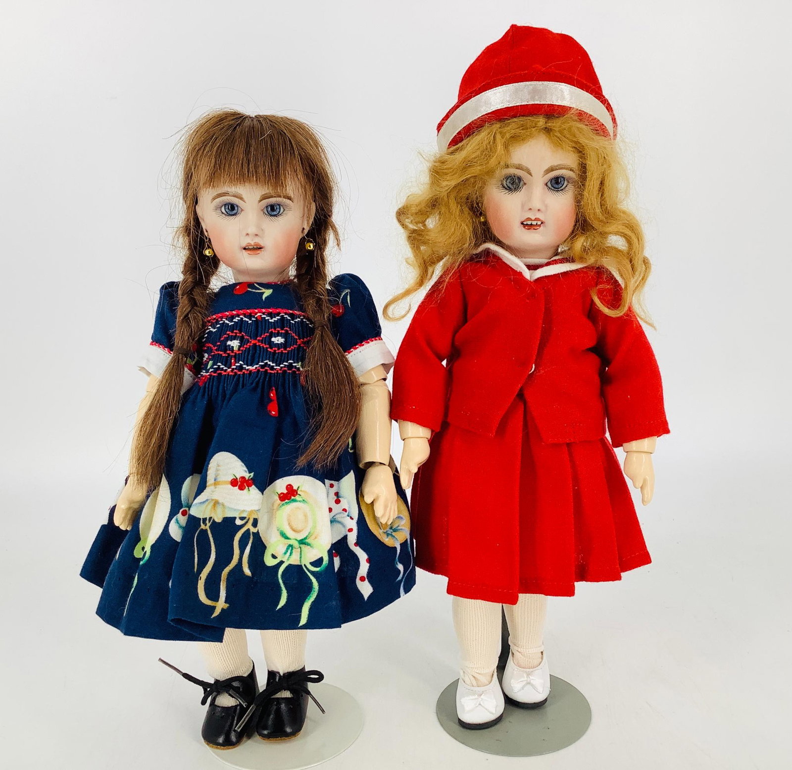 Lot (2) reproduction Bleuettes by Caro Jon. 11 1/4": Lot (2) reproduction Bleuettes by Caro Jon. 11 1/4" dolls, one with brunette human hair wig and one with strawberry blonde mohair. Both with set glass eyes, pierced ears, open mouths with teeth, on jo
