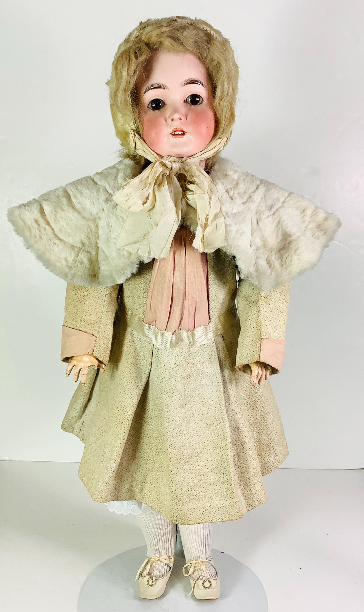 "Queen Louise" bisque socket head girl. 29" doll with: "Queen Louise" bisque socket head girl. 29" doll with mohair wig, sleep eyes have been set, open mouth with teeth, on jointed composition body, wears antique dress and fur cape. Bisque has no apparent