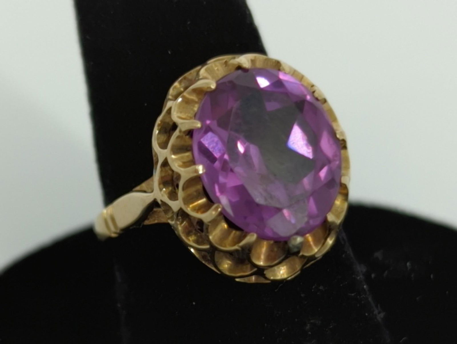 14kt Yellow Gold & Alexandrite Ring: 14kt Yellow Gold & Alexandrite Ring Size 4.25, reverse tapered shank ring featuring an oval cut alexandrite (11.5mm x 9.6mm) set in a raised double buttercup style setting, the center stone features a