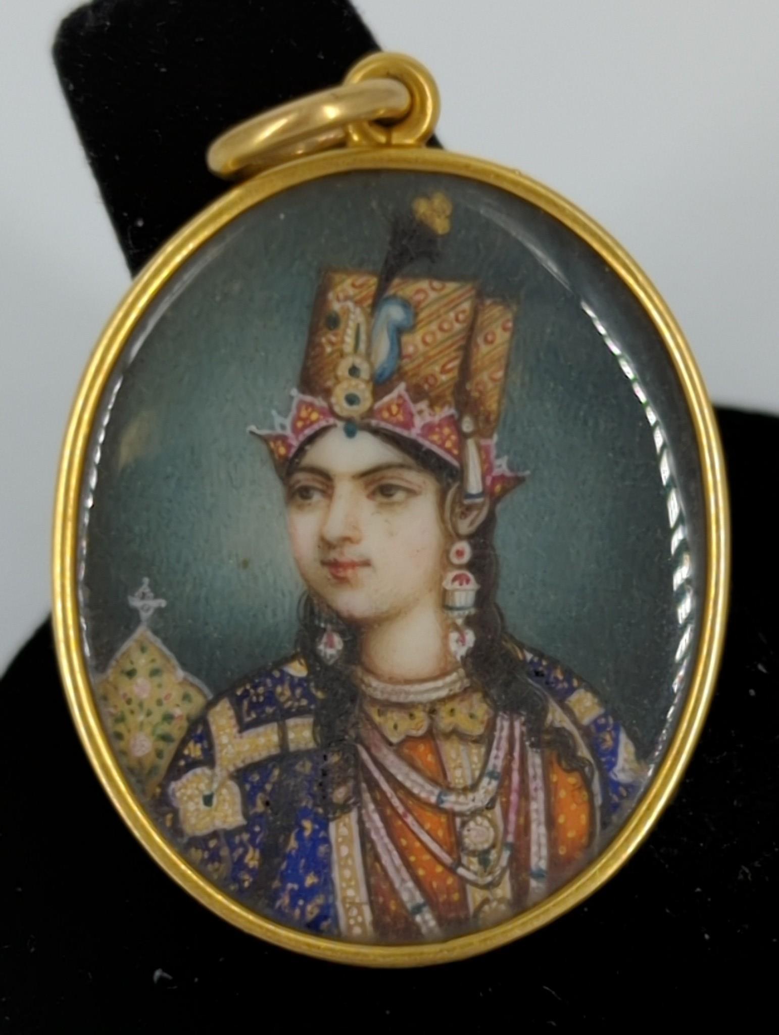Antique / Vintage Hand Painted Mughal Style Portrait: Antique / Vintage Hand Painted Mughal Style Portrait Pendant Likely originating from norther India featuring a royal figure. 1.5" in length, polished gold bezel set portrait with a clear crystal cover