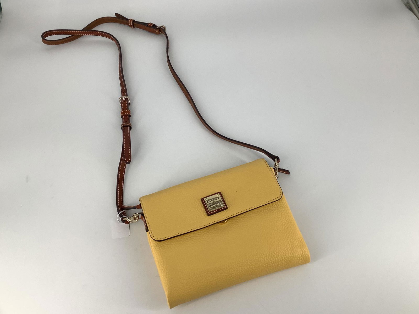 New Dooney & Bourke Crossbody: New Dooney & Bourke Crossbody Mustard yellow crossbody with two main compartments, brown leather strap and red interior lining, branded duster bag included.