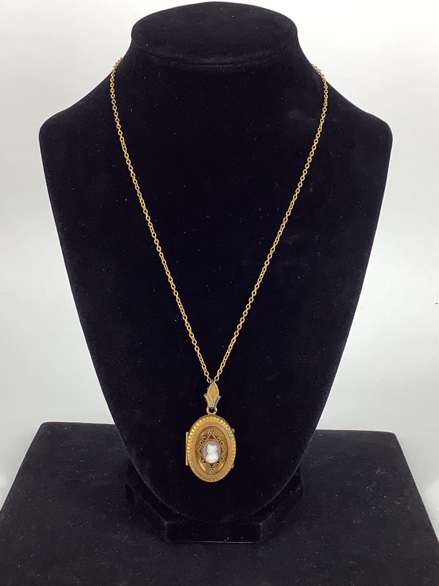 Vintage / Antique Locket: Vintage / Antique Locket 18" god toe chain containing a 1.65" locket style pendant. The locket features a cameo on the front - possibly a pressed design, when opened the locket contains two vintage pi