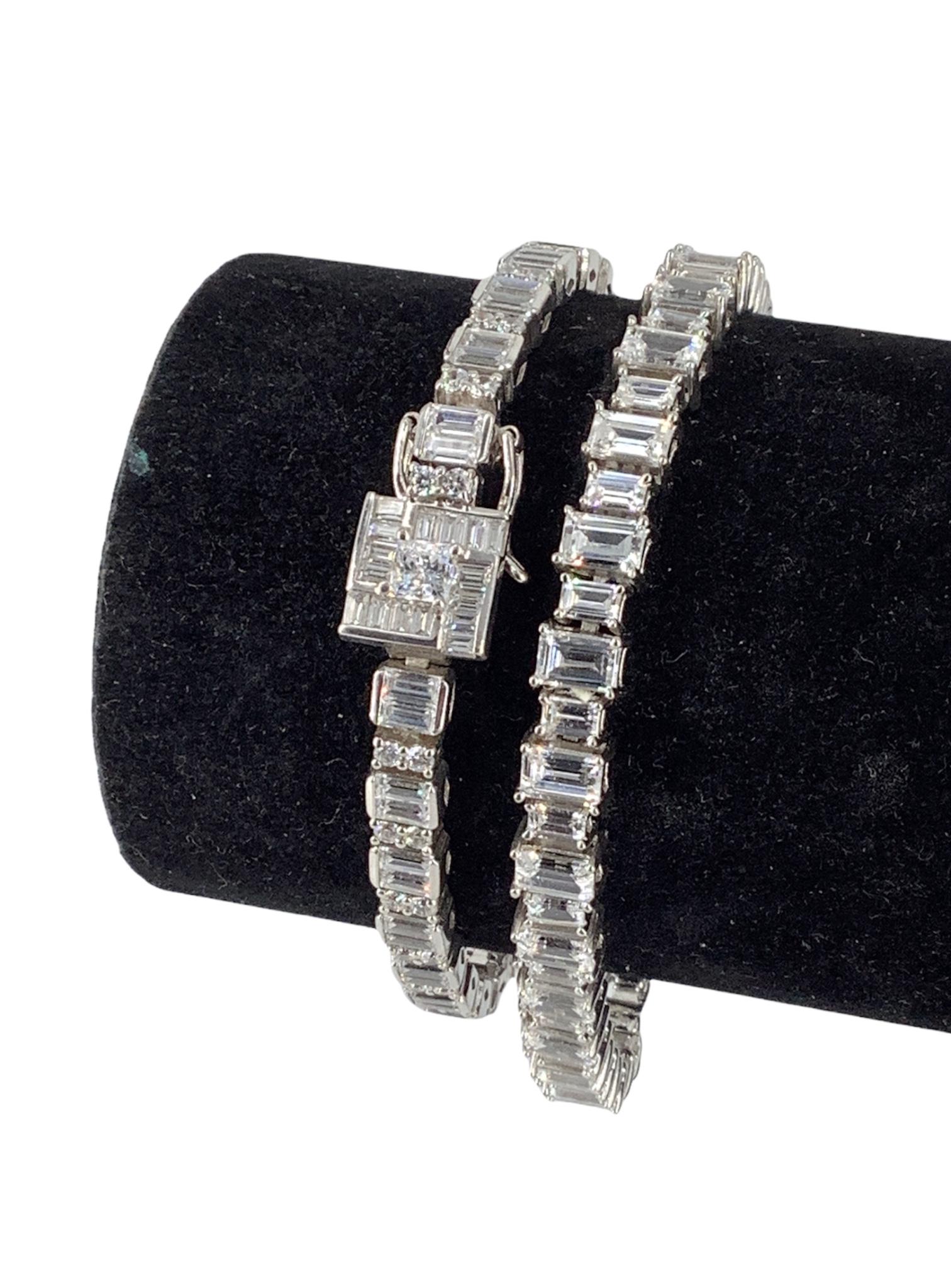 Two Sterling Silver & CZ Tennis Bracelets: Two Sterling Silver & CZ Tennis Bracelets 7" & 7.25" in length, one bracelet features emerald cut and round cut clear cz stones accented with a geometric style embellishment on the box clasp closure, 