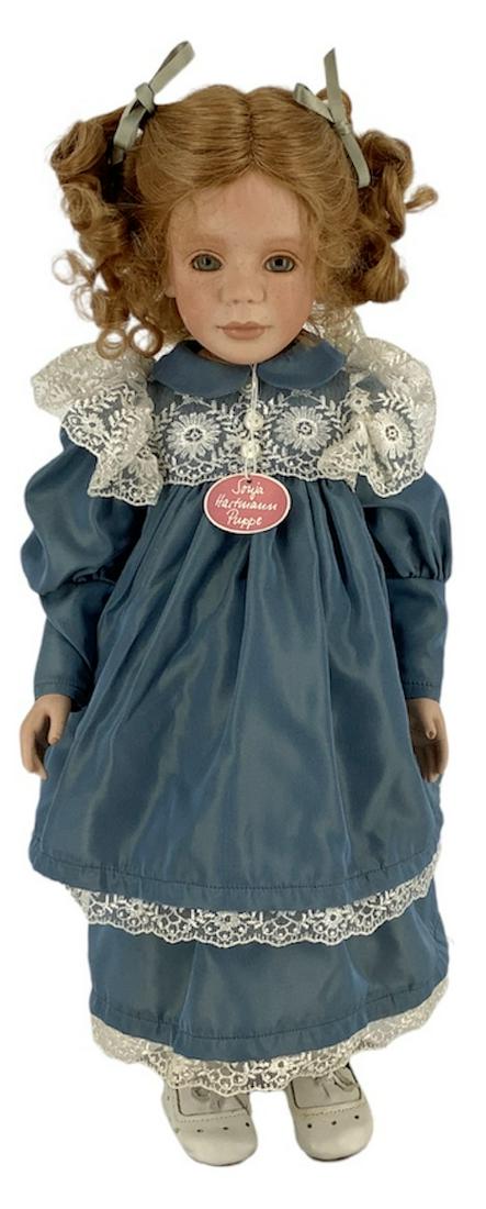 Porcelain artist doll "Simone" by Sonja Hartmann. 20": Porcelain artist doll "Simone" by Sonja Hartmann. 20" swivel head doll with human hair wig, inset glass eyes, on porcelain upper torso with porcelain arms, jointed hands, cloth lower torso and upper l