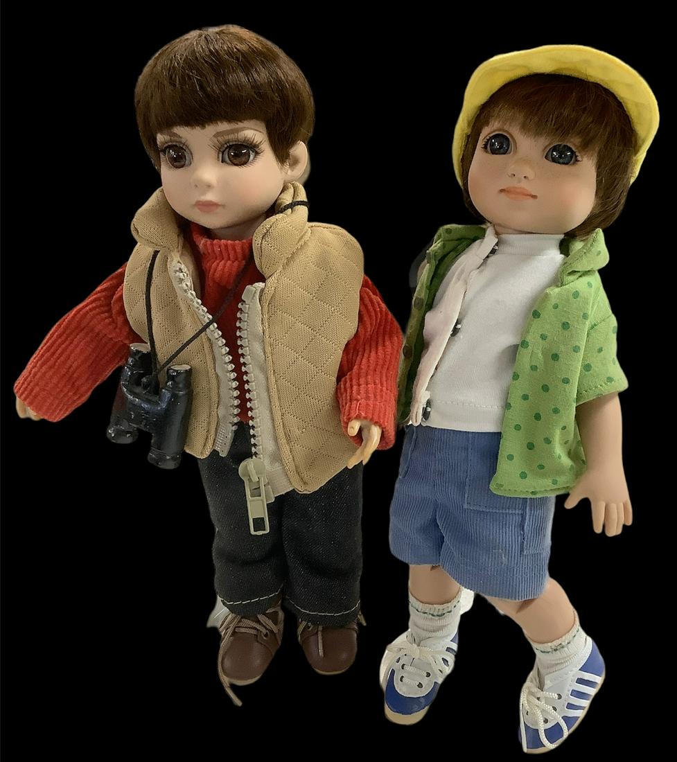 Lot of 2 hard vinyl, eye inset dolls with eyelashes @: Lot of 2 hard vinyl, eye inset dolls with eyelashes @ approx 10 1/2" tall. Doll w/binocular accessory is marked Effanbee, circa 2012. Doll w/cap is marked Michael, and his white shirt shows some dirt.