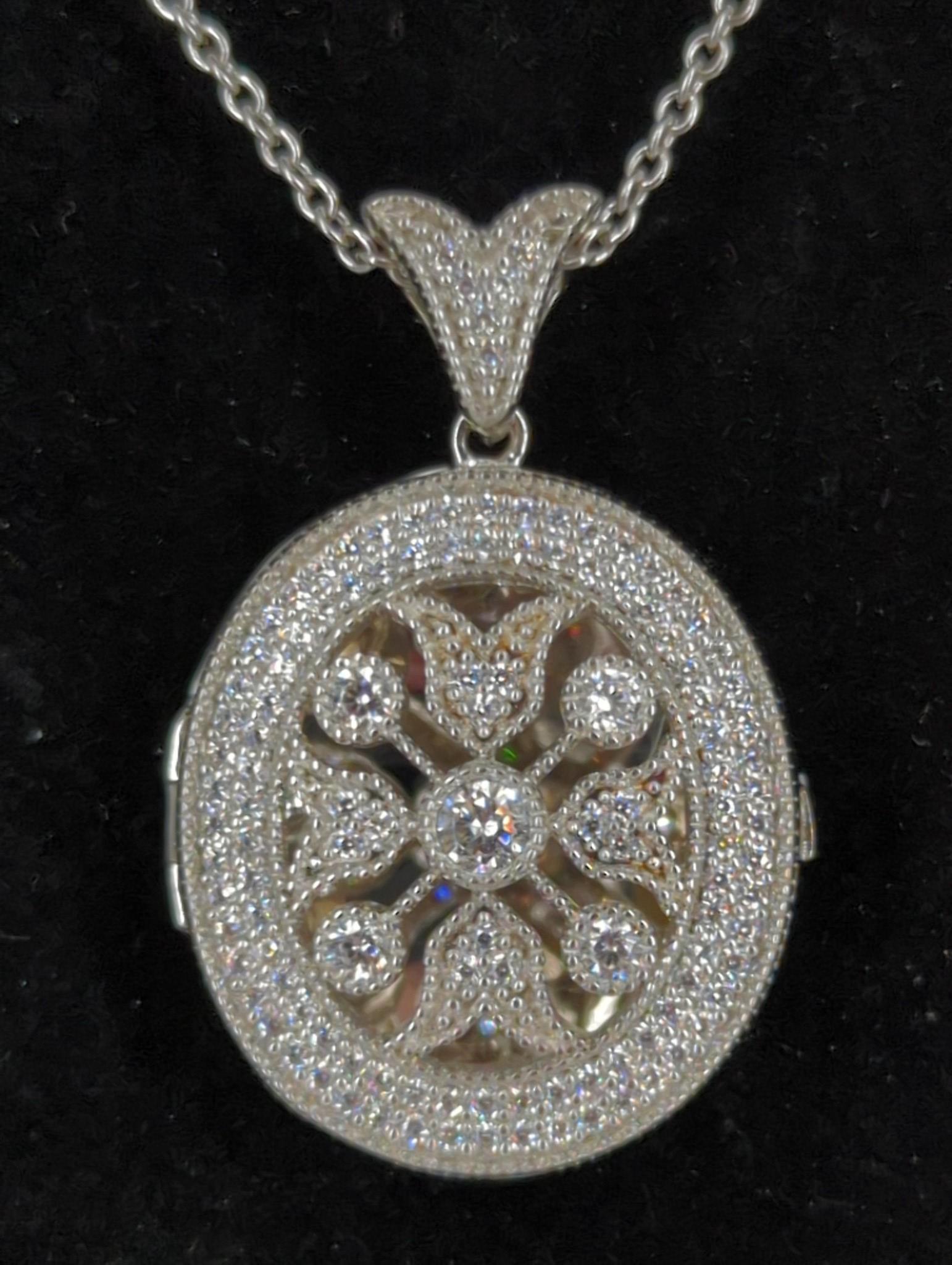 Sterling Silver & CZ Locket: Sterling Silver & CZ Locket 18"+ curb link chain containing a 1.2" locket that features an openwork design adorned with clear cz stones and finished with mill-grain edge work, stamped and tested (0.29