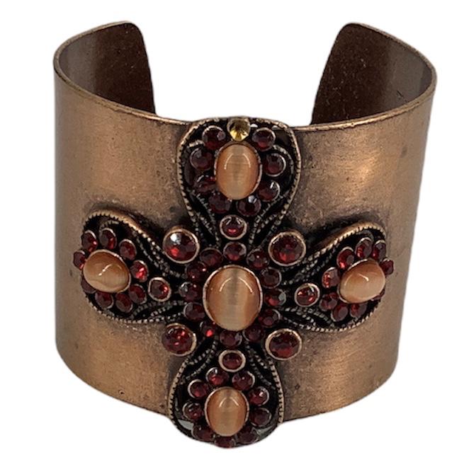 Copper Cuff: Copper Cuff Split shank design with an inner diameter of 2.25" (1.96" wide) featuring a cross motif on the front composed of rhinestones and peach colored cats eye cabochons, unsigned piece, electroni