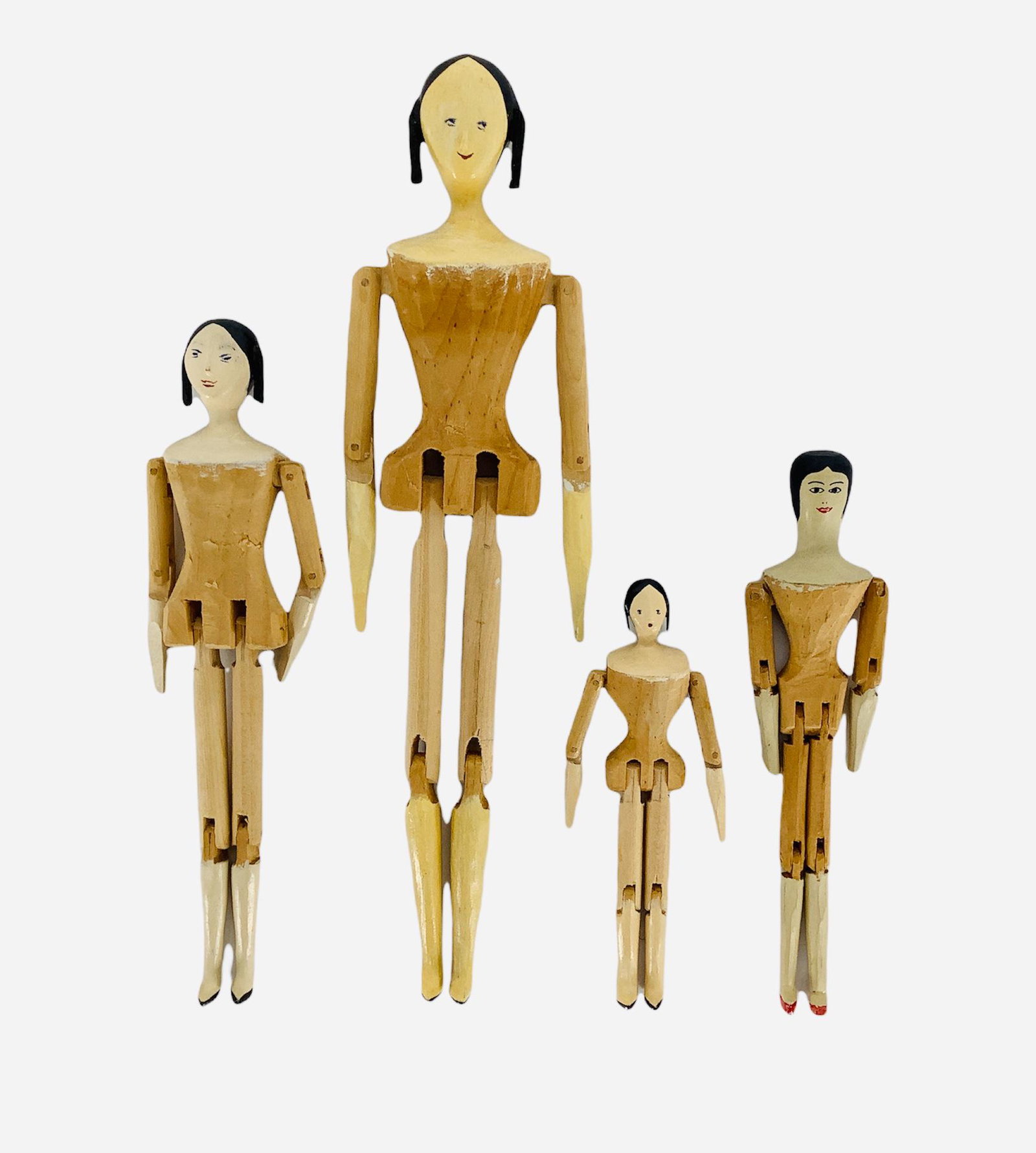 Lot of 4 artisan made peg-wooden dolls ranging from 4 1/2" to 9" tall. Dolls have painted features, (1 of 2)