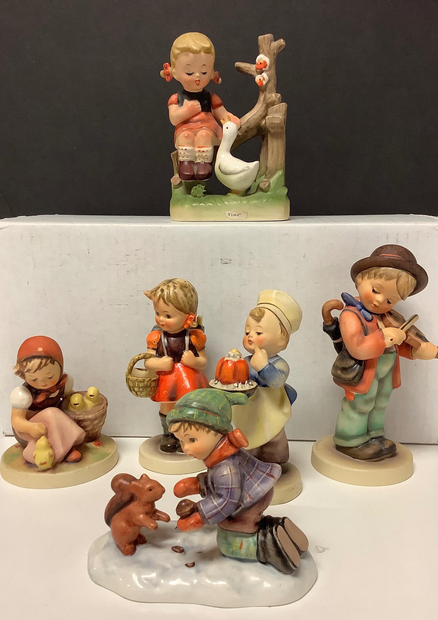 Lot of figurines, 5 with Hummel markings. Tallest figure is 6" and there is some crazing on base of: Lot of figurines, 5 with Hummel markings. Tallest figure is 6" and there is some crazing on base of little boy chef. Figurine on top row is not marked as a Hummel, see picture for hallmarks.